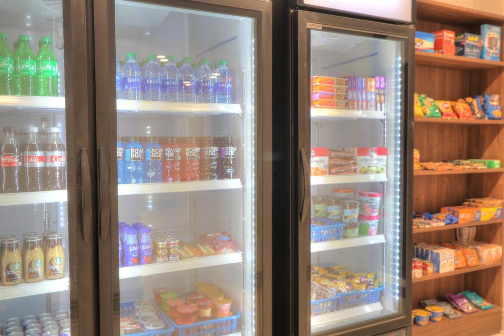 a refrigerator filled with lots of different types of drinks at Holiday Inn Express Hotel & Suites Mobile Saraland by IHG in Saraland