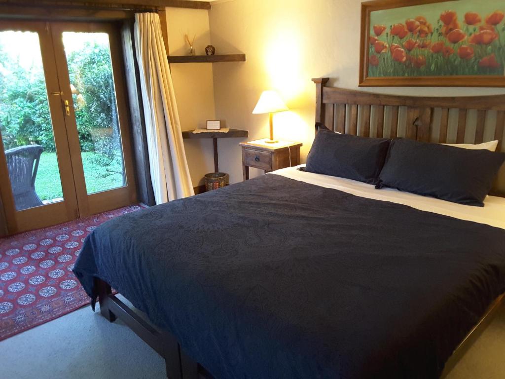 a bedroom with a large bed and a window at Wanaka Stonehouse in Wanaka