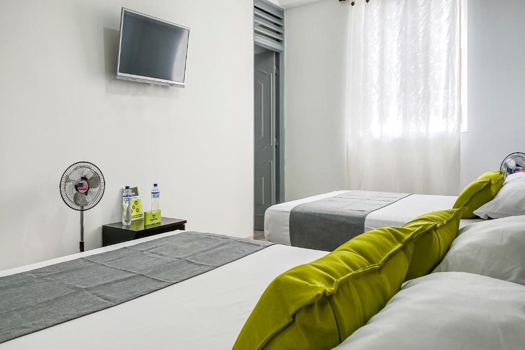 Postel nebo postele na pokoji v ubytování Ayenda 1138 Apartahotel 109