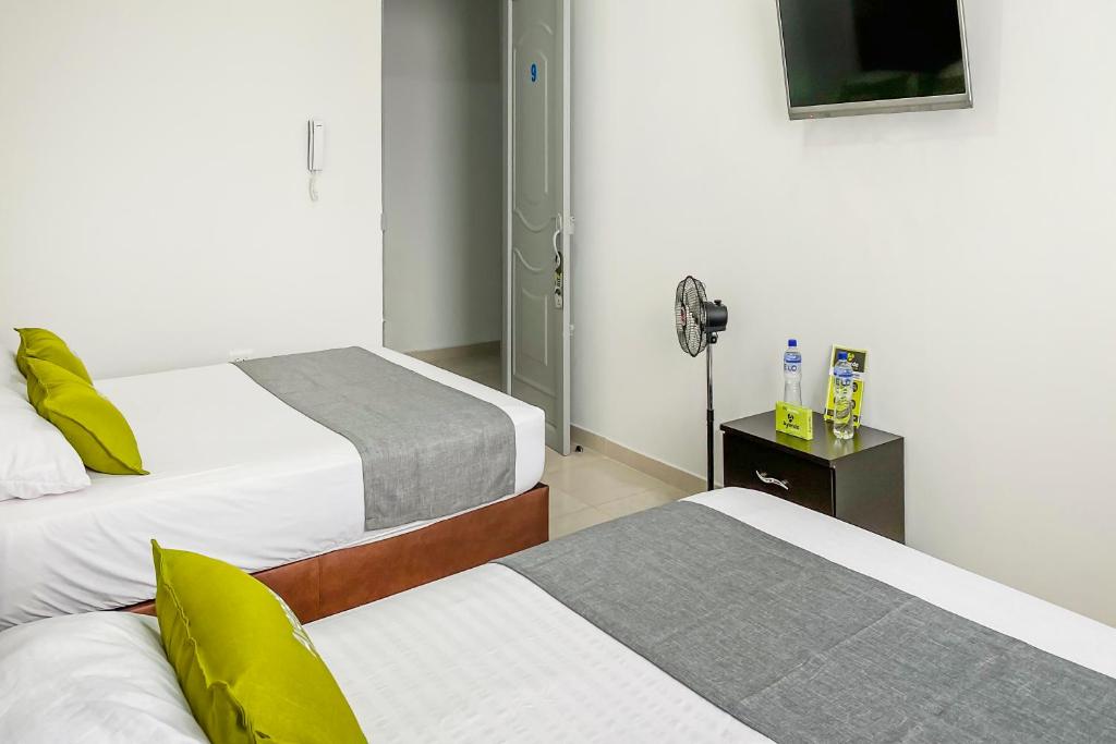 Postel nebo postele na pokoji v ubytování Ayenda 1138 Apartahotel 109