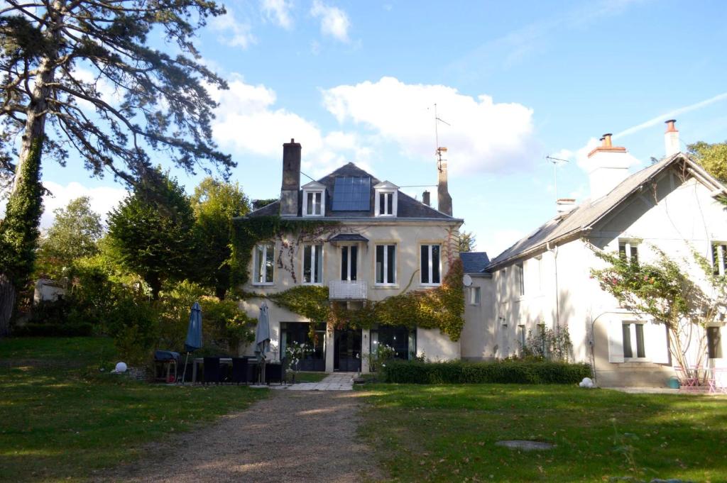 a large white house with a tree at ZenBreak Chambre Vue sur Parc in Saint-Jean-le-Blanc