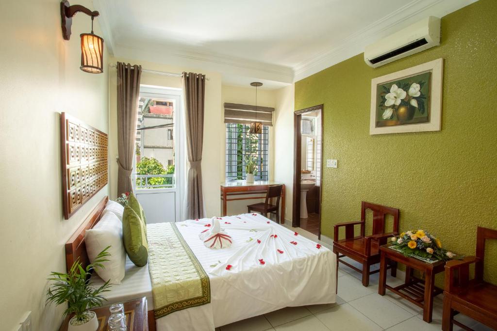 a bedroom with a bed in a room at Amigo Hue Hotel in Hue