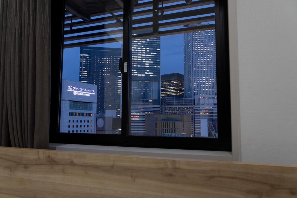 a view of a city skyline from a window at Washington R&B Hotel Nagoya Shinkansenguchi in Nagoya
