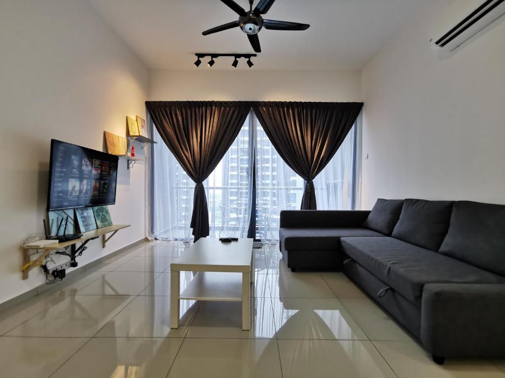 a living room with a couch and a ceiling fan at Thermospace Atlantis C-34-08 Melaka City in Melaka