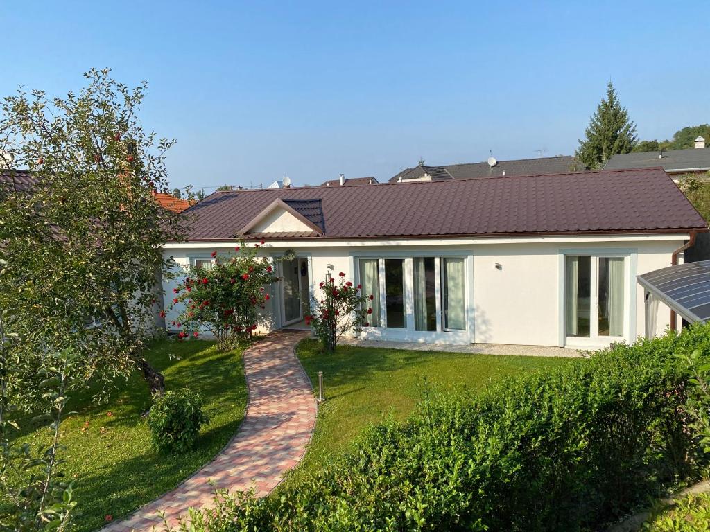 a house with a garden and a driveway at Pension Julia in Banka