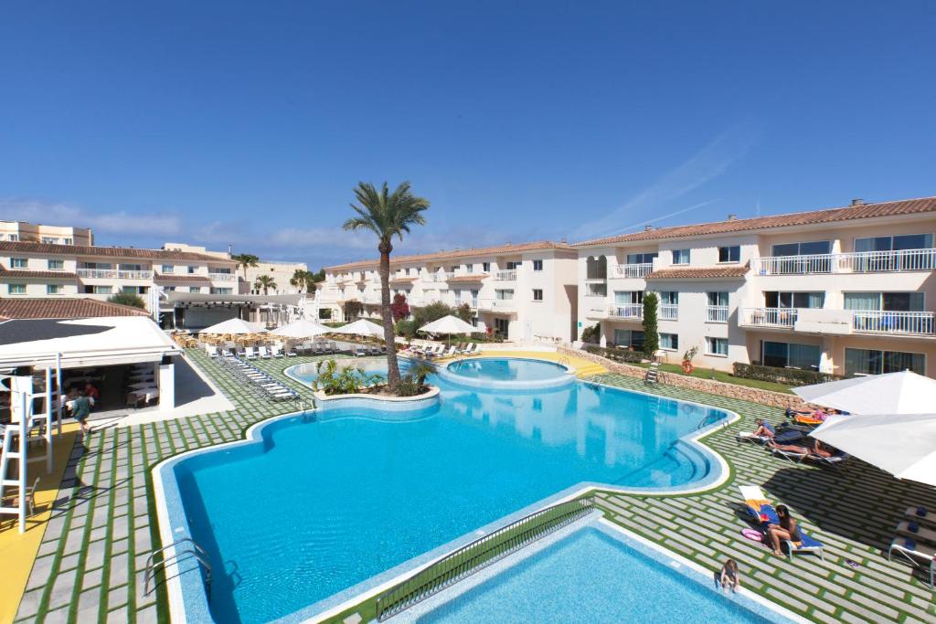 a large swimming pool in front of a building at Aparthotel Isla de Cabrera in Colonia Sant Jordi