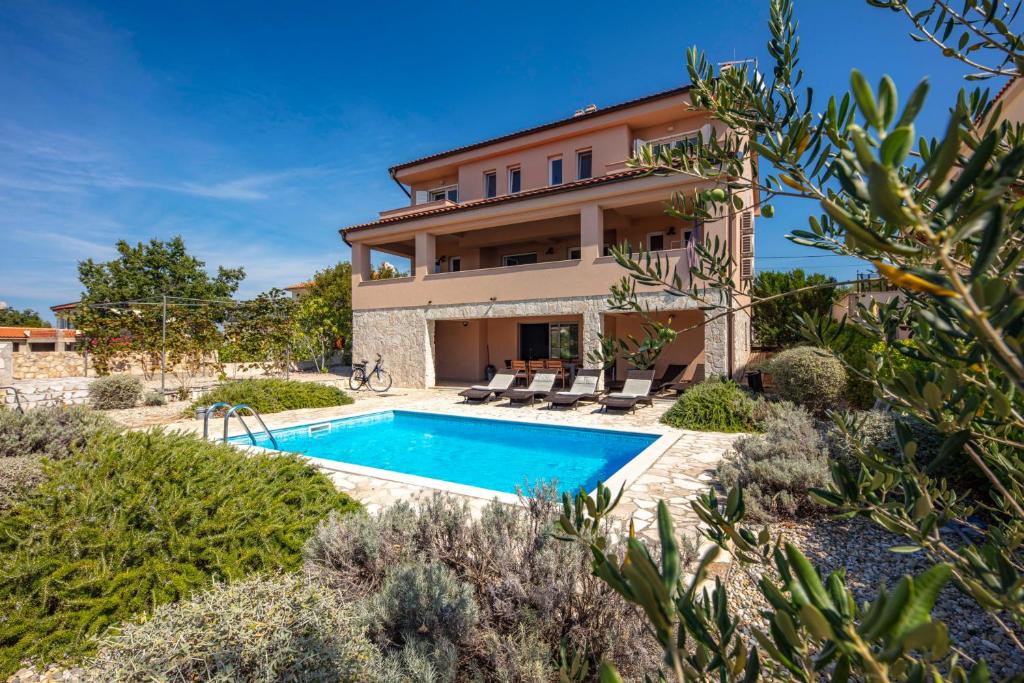 uma vista exterior de uma villa com piscina em More More Villa 4 All em Linardići