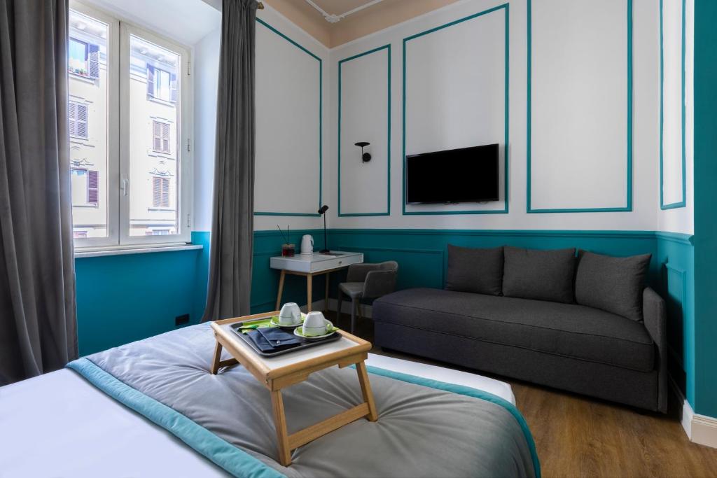 a living room with a bed and a couch at Hotel Coppede' in Rome