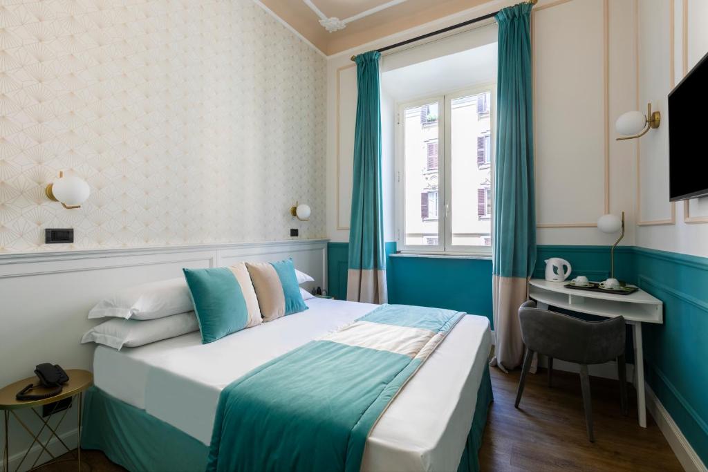 a hotel room with a bed and a desk at Hotel Coppede' in Rome
