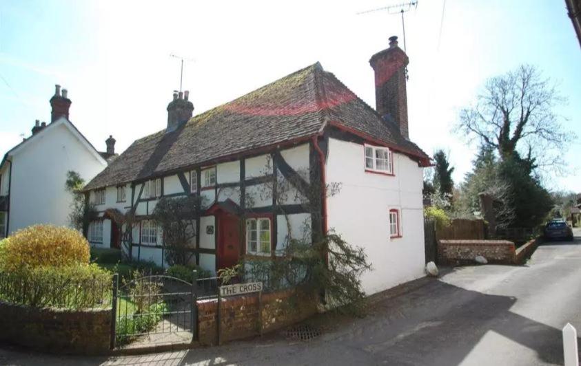 a white house with a red door at Honeysuckle Cottage- East Meon in East Meon