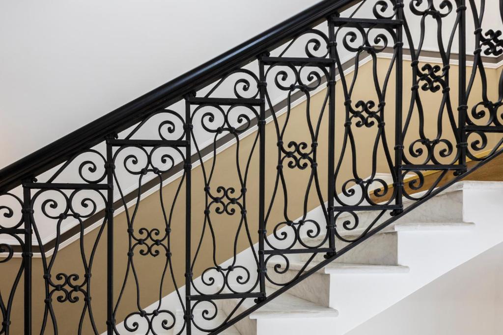 a stair railing with black wrought iron railings at Hotel Coppede' in Rome