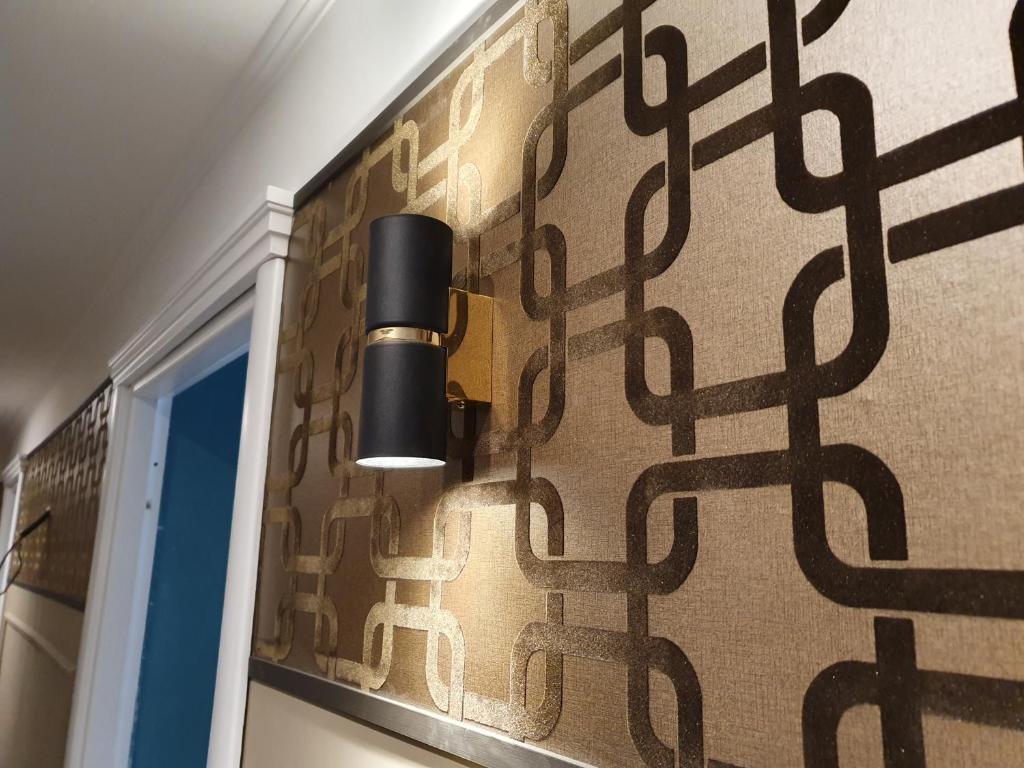 a room with a wall covered in patterned wallpaper at Hotel Coppede' in Rome