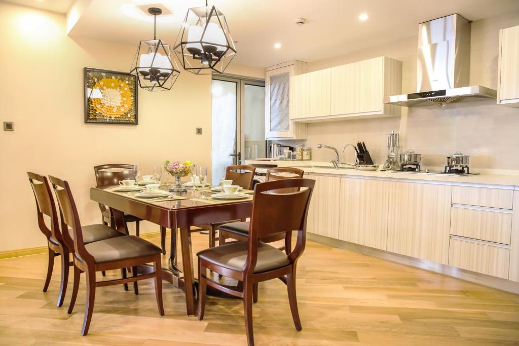 a kitchen and dining room with a table and chairs at Green Court Residence Jinqiao Diamond Shanghai in Shanghai