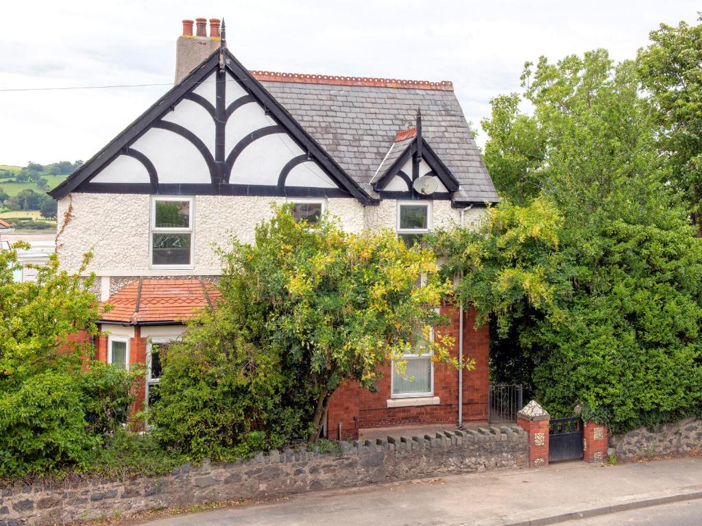 a house with a black and white roof at Bryn Y Mor in Colwyn Bay