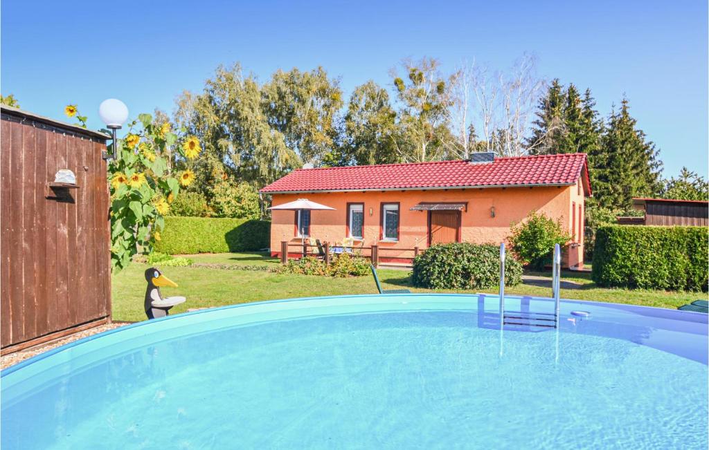 a swimming pool in a yard with a house at Lovely Home In Schorfheide With Wifi in Schorfheide