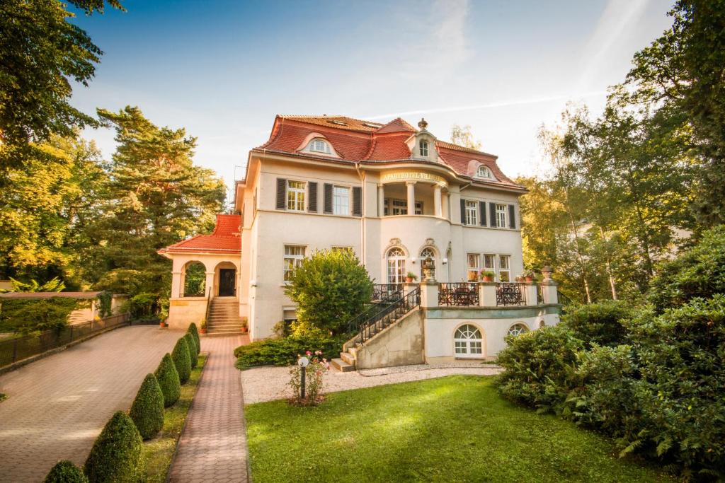 ein großes Haus mit rotem Dach in der Unterkunft Aparthotel Villa Freisleben in Dresden