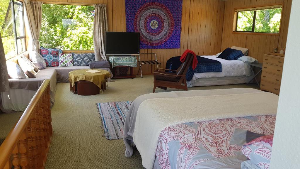 a bedroom with two beds and a tv at Champion Road Studio in Stoke
