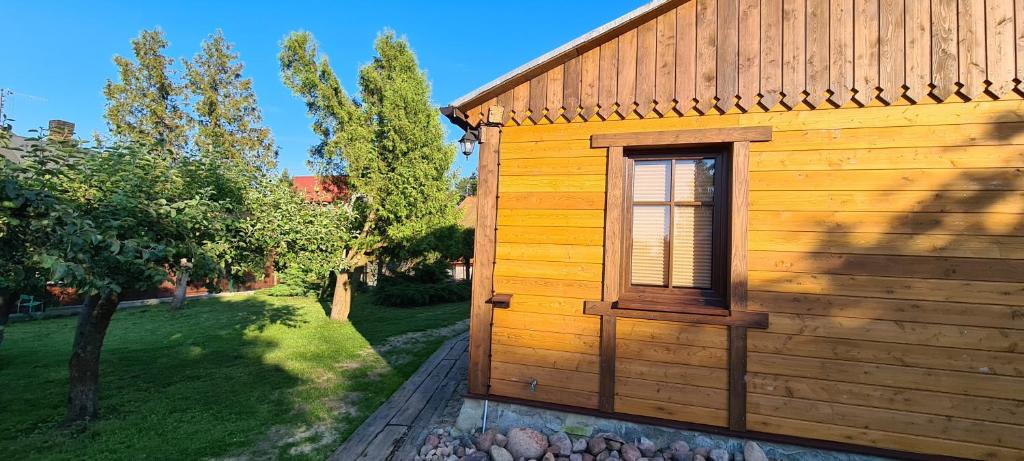 a wooden building with a window on the side of it at Dom Dziadka in Janów Podlaski