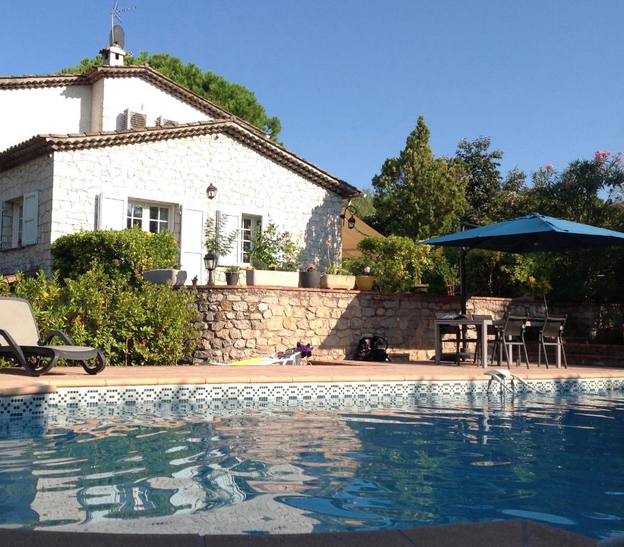 a house and a swimming pool in front of a house at Villa Alessia in Antibes