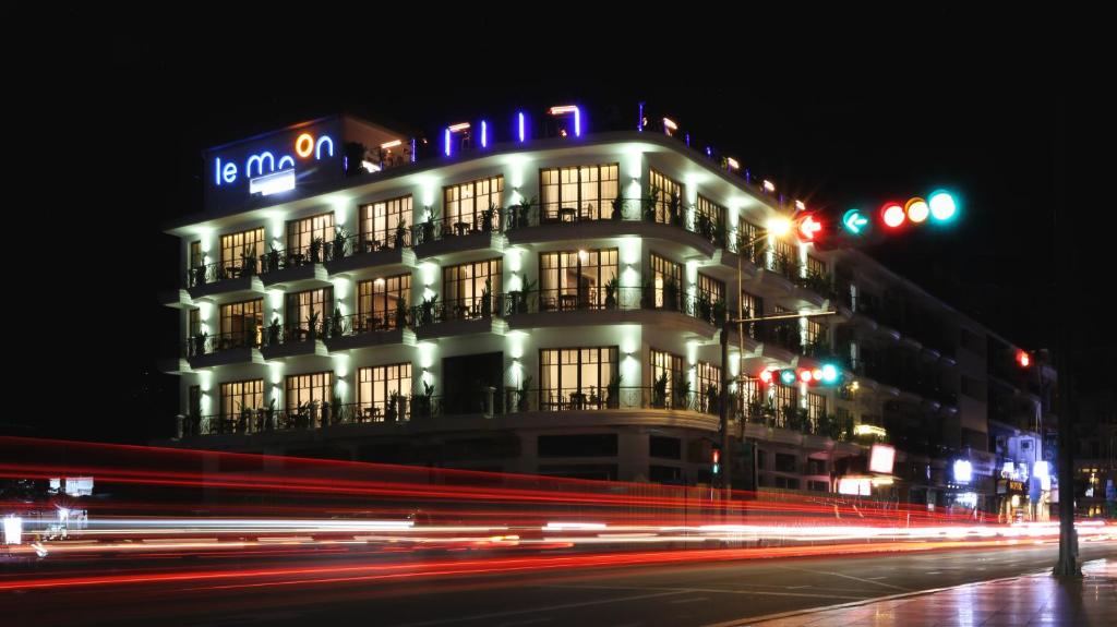 a city street at night with a large building at Amanjaya Pancam Suites Hotel in Phnom Penh