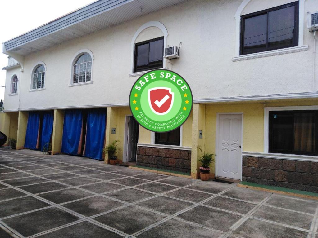 a building with a green sign in front of it at RedDoorz near SM Batangas City in Batangas City