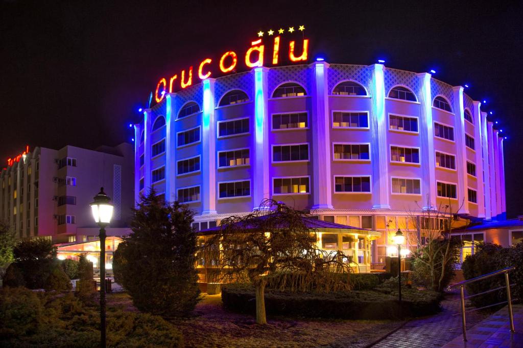 a hotel building with a lit up sign on it at Afyon Orucoglu Thermal Resort in Afyon
