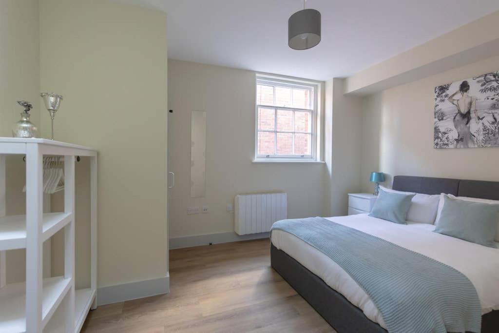 a bedroom with a large bed and a window at Hereford City Centre - Apartment 4, Isabella House - Modern Apartment In The Heart of The City - Sleeps 4 Guests - Hosted by RENTMYHOUSE in Hereford