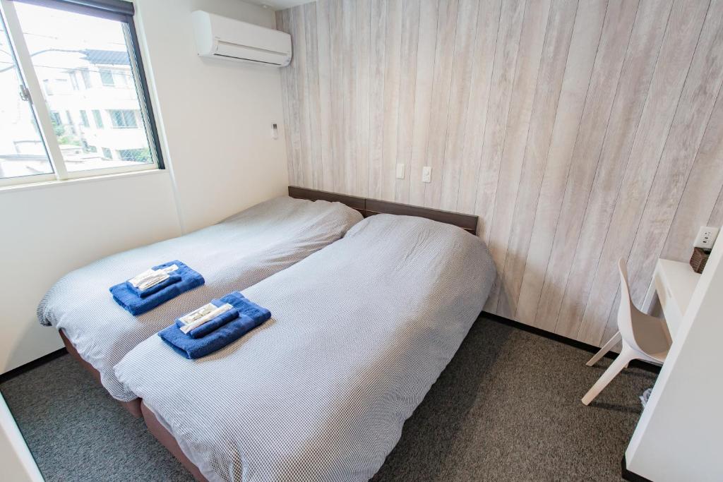 Postel nebo postele na pokoji v ubytování Port House Hatsudai