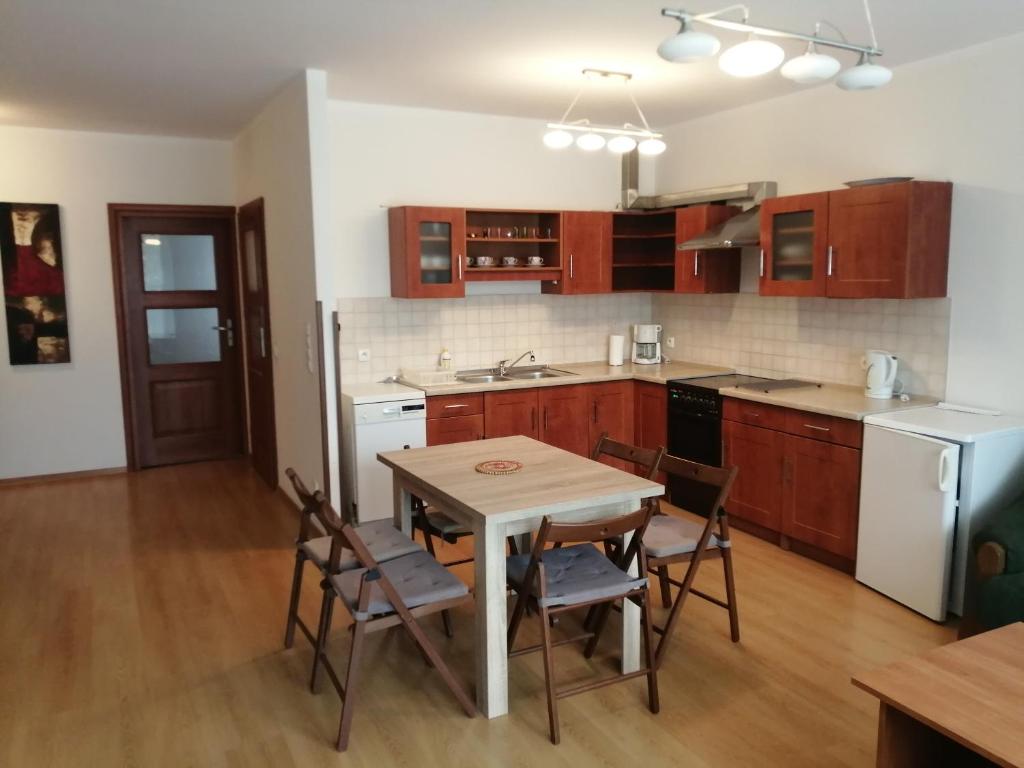 a kitchen with a table and chairs in a room at Apartament Słoneczny in Ustroń