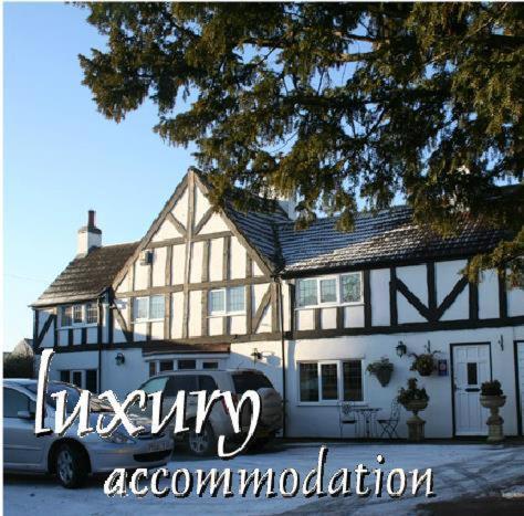 a house with a car parked in front of it at Newark Lodge Guest House in Newark-on-Trent