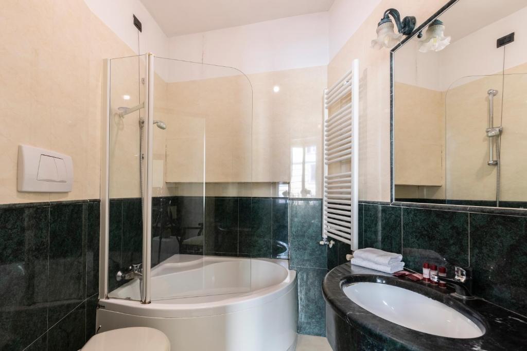 a bathroom with a tub and a sink at Hotel Coppede' in Rome