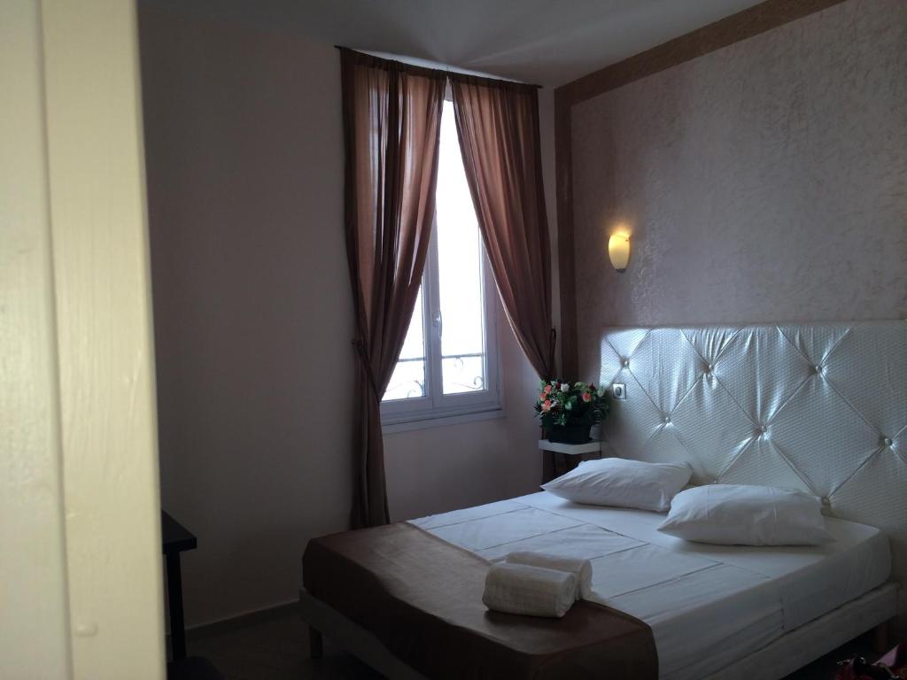 a bedroom with a large bed with a window at Arcotel Cannes 4 minutes du Palais des Festivals - NEW MANAGEMENT NEW TEAM - OLD REVIEVV in Cannes