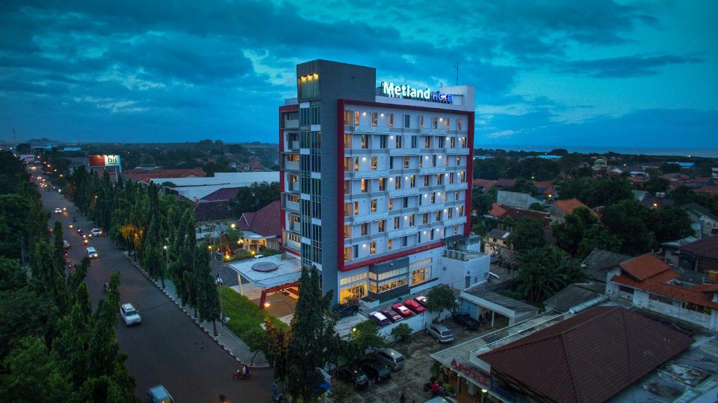 a tall building with a hotel sign on top of it at Metland Hotel Cirebon by Horison in Cirebon