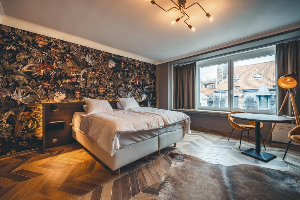 ein Schlafzimmer mit einem Bett mit einer großen Blumentapete in der Unterkunft Prado Next Door in Ostende
