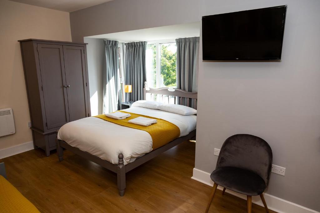 - une chambre avec un lit et une télévision à écran plat dans l'établissement AA Alexander House, à Newcastle upon Tyne