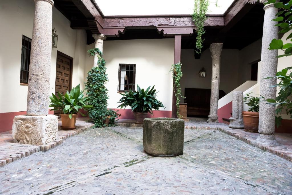 a courtyard with potted plants in a building at A dream in Toledo in Toledo