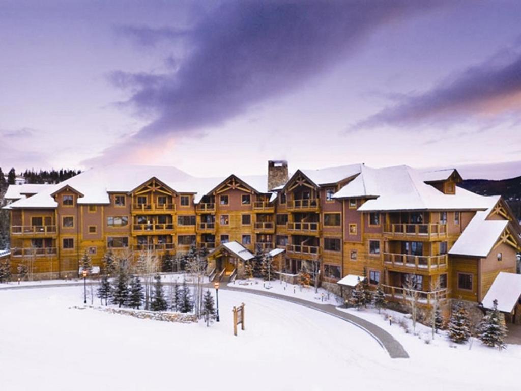 a large house with a snow covered ski slope at Mountain Thunder Lodge in Breckenridge