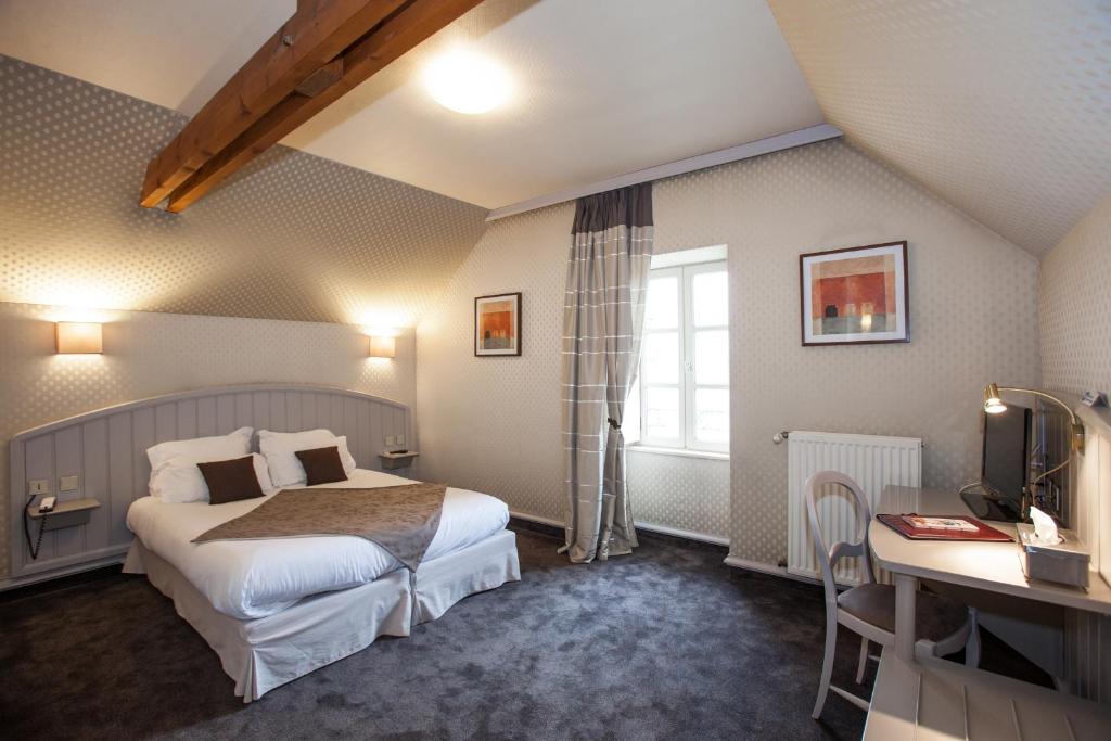 Habitación de hotel con cama y escritorio en Cit'Hotel le Challonge, en Dinan