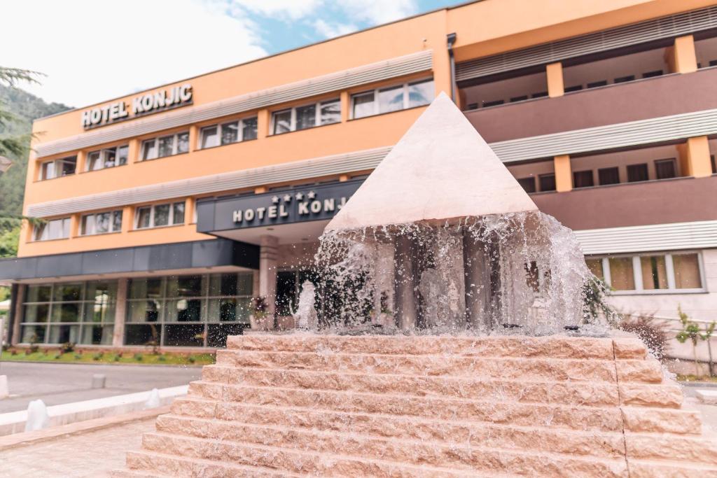 a water fountain in front of a building at Garden City Hotel Konjic in Konjic