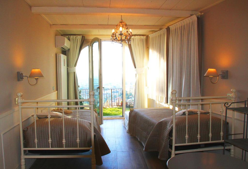 ベルガモにあるBed & Breakfast Sant'Erasmoのベッドルーム1室(ベッド2台、大きな窓付)