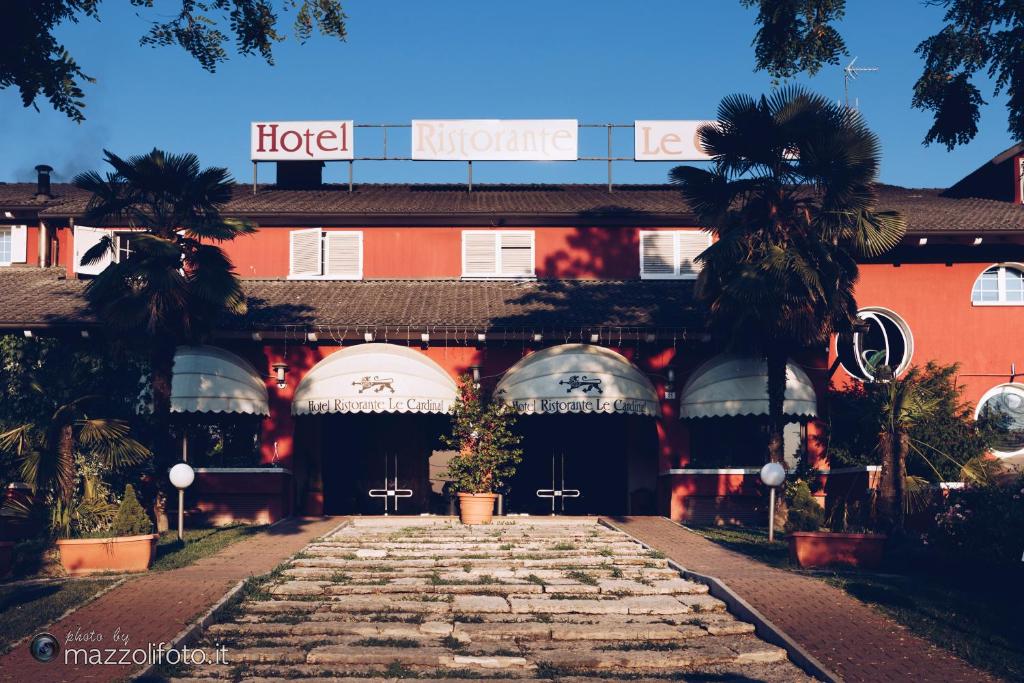 a hotel with a stone walkway in front of it at Hotel Le Cardinal in Bastiglia