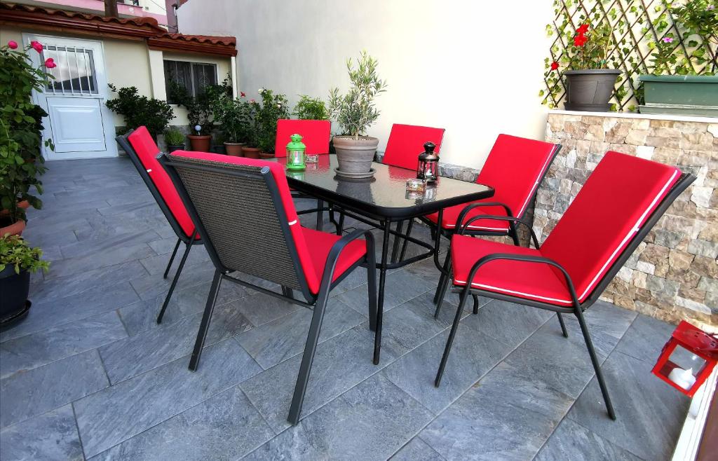 a black table and red chairs on a patio at Delphic Horizons in Delphi