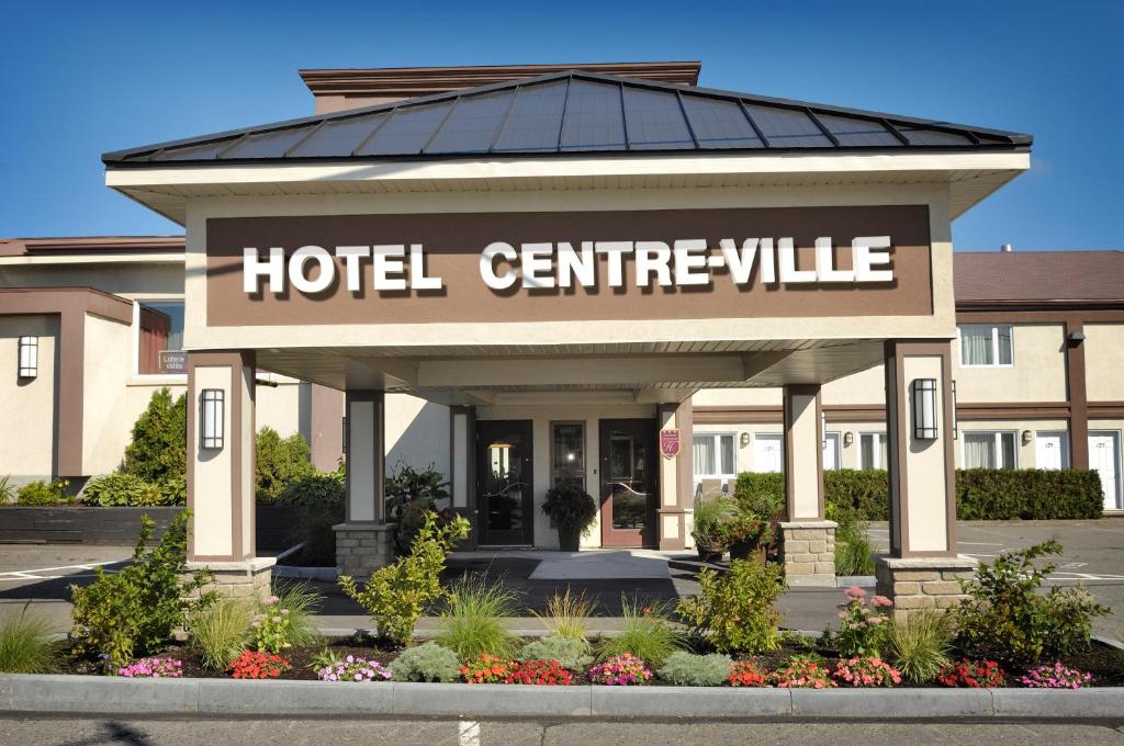ein Hotelgebäude mit einem Hotelserville-Schild in der Unterkunft Hôtel Centre-Ville in Montmagny