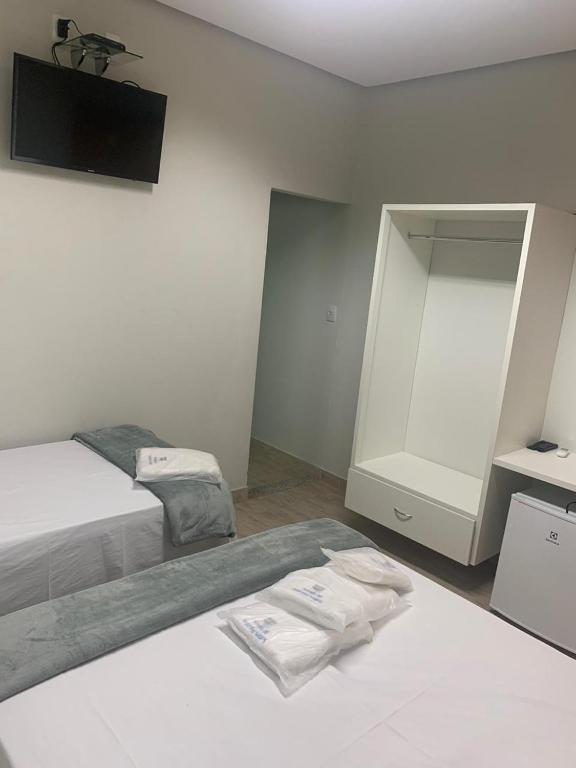 Postel nebo postele na pokoji v ubytování Suites Paraíso de Minas