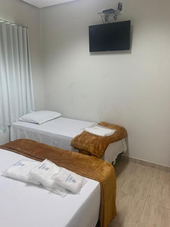 Postel nebo postele na pokoji v ubytování Suites Paraíso de Minas