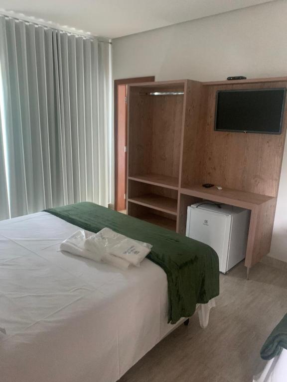 Postel nebo postele na pokoji v ubytování Suites Paraíso de Minas