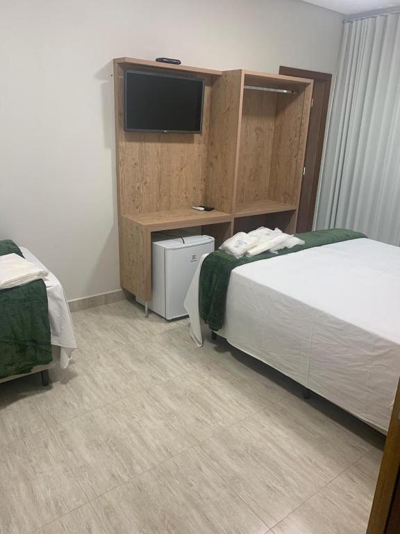 Postel nebo postele na pokoji v ubytování Suites Paraíso de Minas