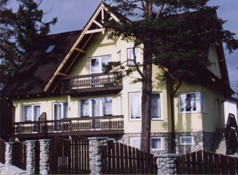a large house with a fence in front of it at Vila Altwaldorf B&B Vysoke Tatry in Stará Lesná