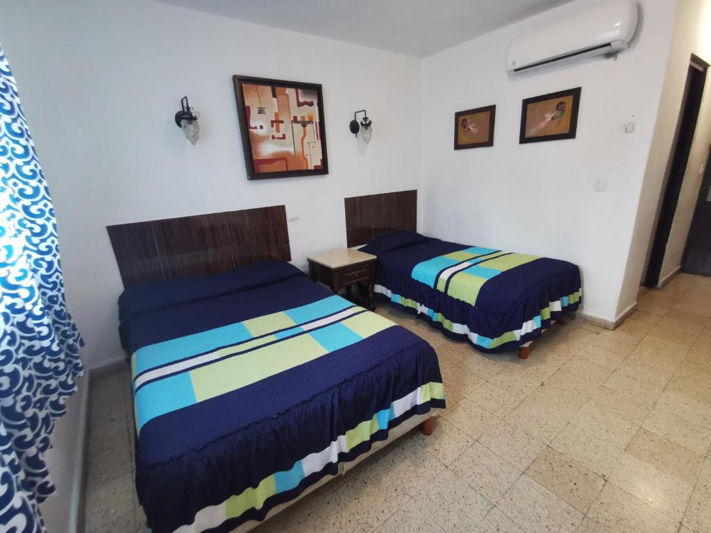 Postel nebo postele na pokoji v ubytování Hotel Las Dalias Inn