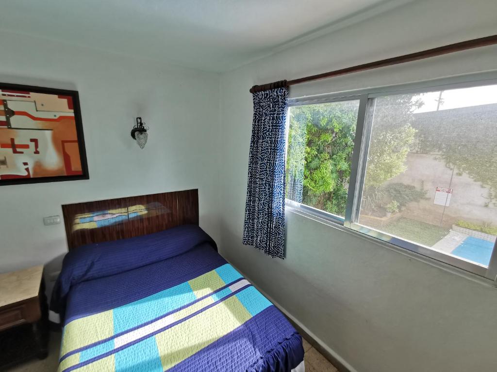 Postel nebo postele na pokoji v ubytování Hotel Las Dalias Inn